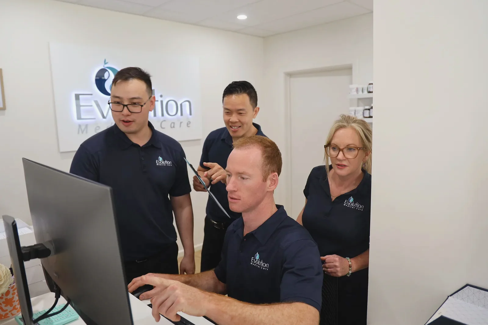 Clinic team working together at a computer